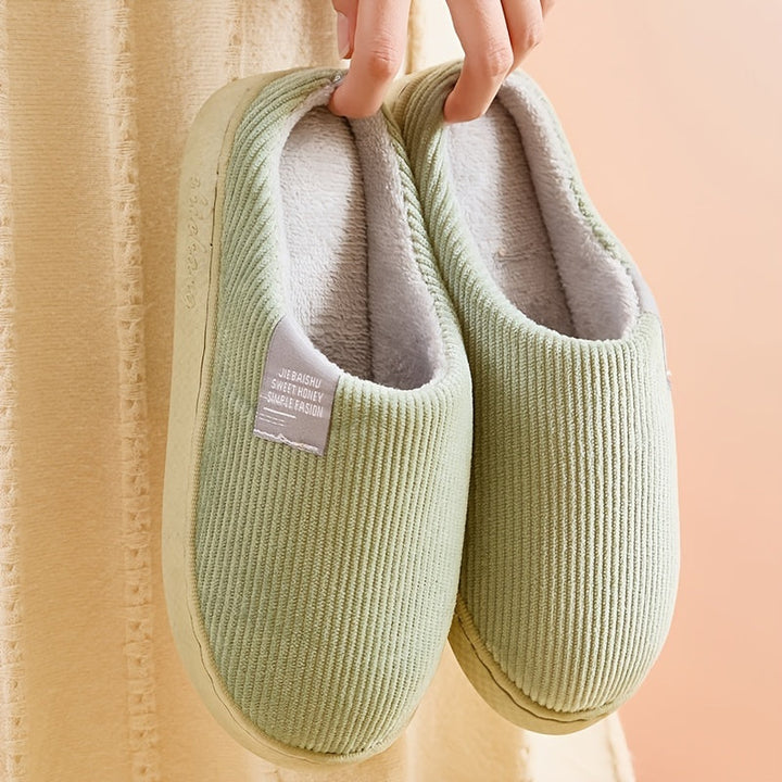 Soft women's indoor slippers with plush lining and non-slip soles, perfect for relaxing home wear.