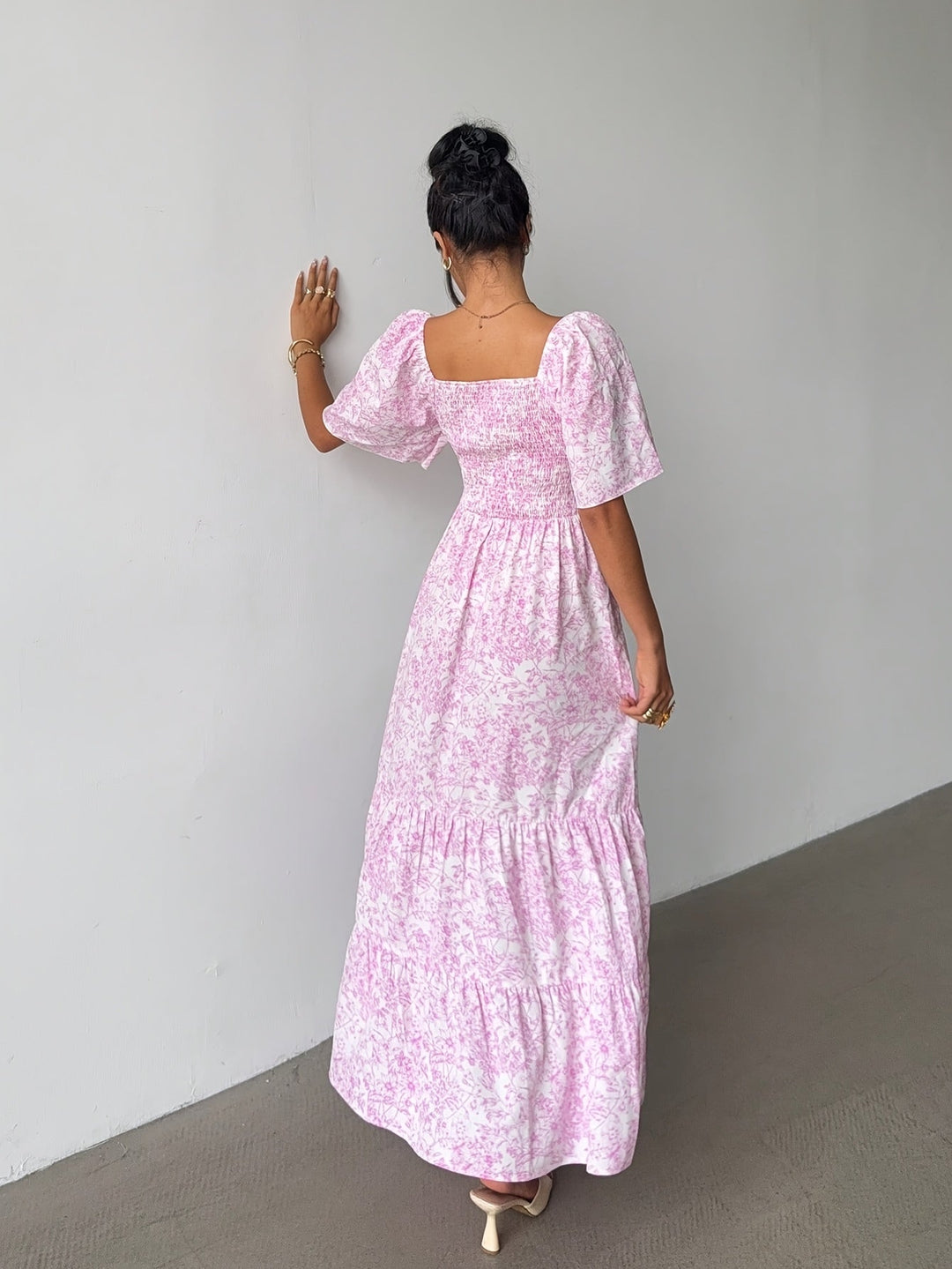 Feminine floral maxi dress with sweetheart neckline & tiered skirt, ideal for party wear or vacation style.