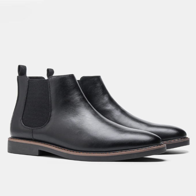 Overhead view of stylish men's black leather Chelsea boots, showcasing their sleek slip-on design.