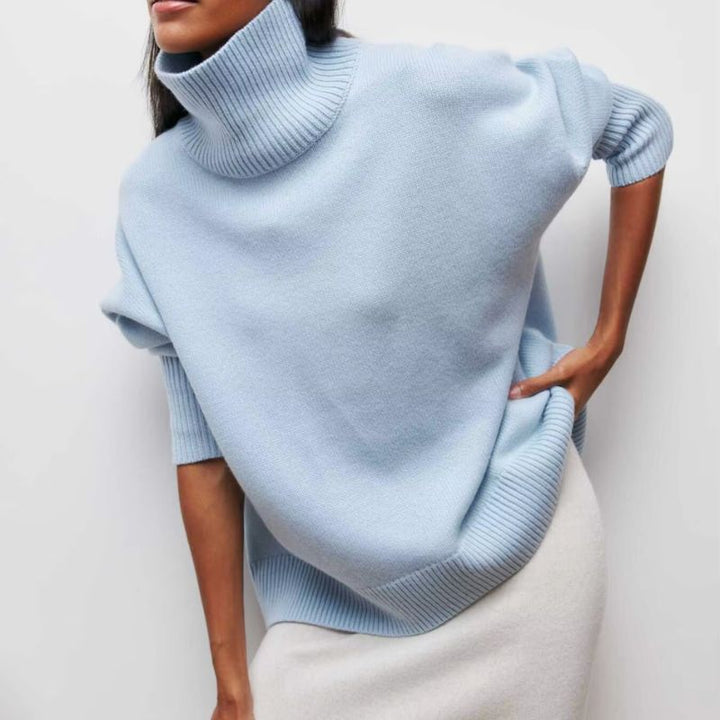 Stylish women's oversized knit turtleneck sweater. Cozy casual wear, ideal for cold weather.