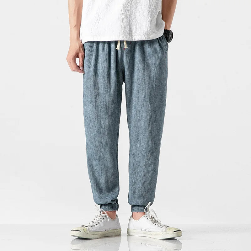 Athletic men's tapered joggers with elastic waist & drawstring, perfect for active lifestyle or comfortable casual wear.