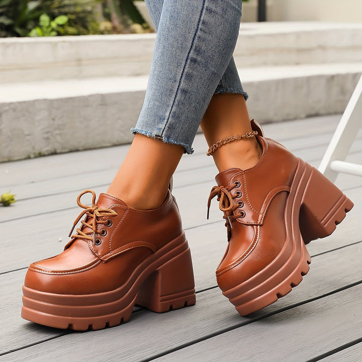 Women's black chunky platform oxfords with lace-up detail, perfect for retro fashion & dress casual style.