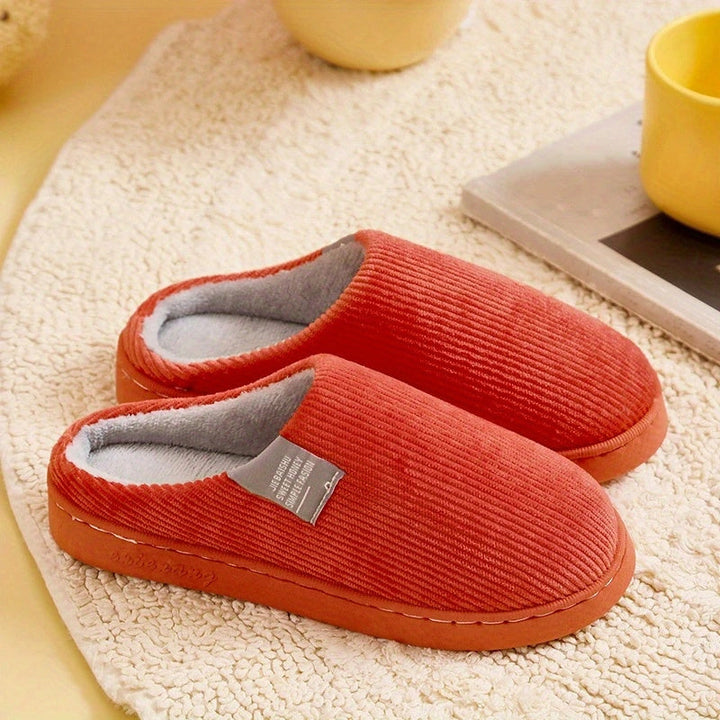 Stylish women's plush house slippers with a comfortable design & non-slip sole for safe indoor wear.
