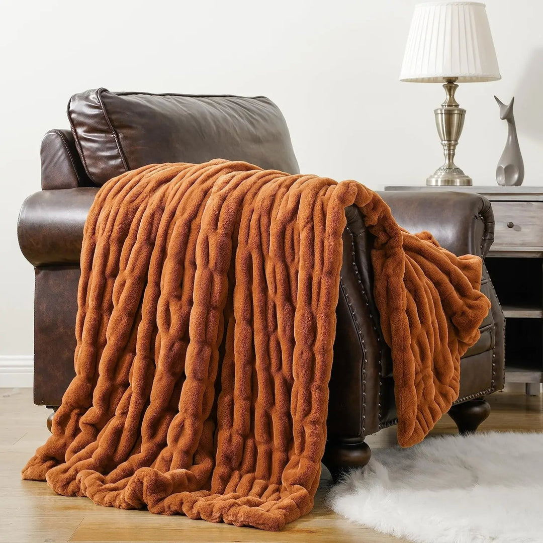Plush faux fur throw blanket, a luxurious, soft, and cozy home decor accessory.