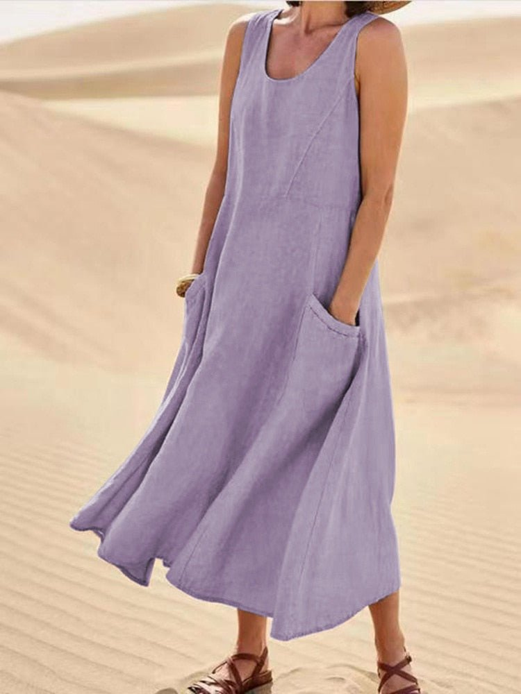 Flowy women's sleeveless midi dress with a scoop neck and pockets, offering comfort for casual summer days.