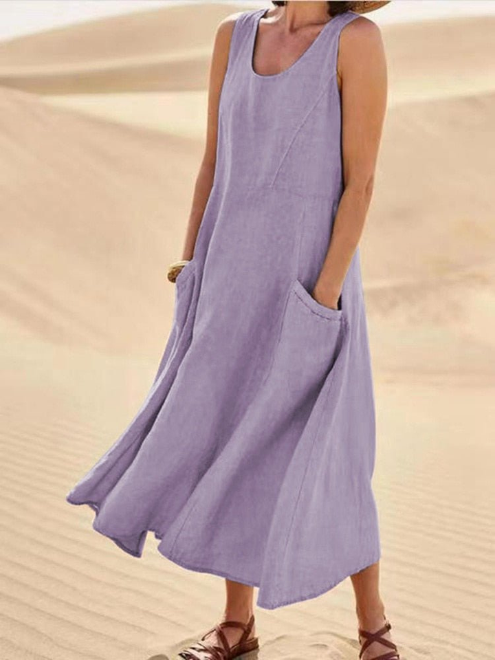 Flowy women's sleeveless midi dress with a scoop neck and pockets, offering comfort for casual summer days.