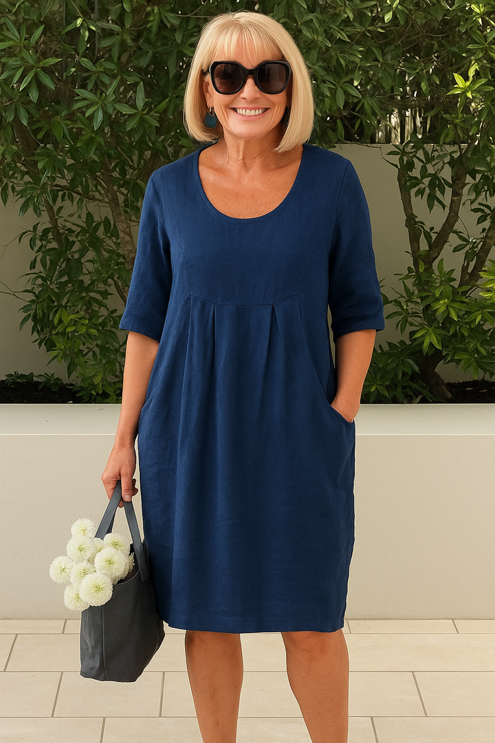 Casual summer day dress for women, featuring pleats, bust pockets, and a stylish midi length.