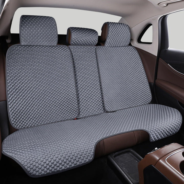 Breathable car seat protector with cooling effect in grey. Protects vehicle interior, enhances comfort.