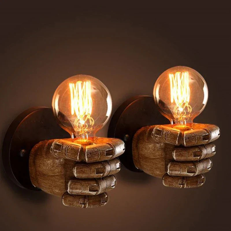 Resin sculpted fist sconce for dramatic wall lighting. Adds unique, artistic flair to commercial decor.