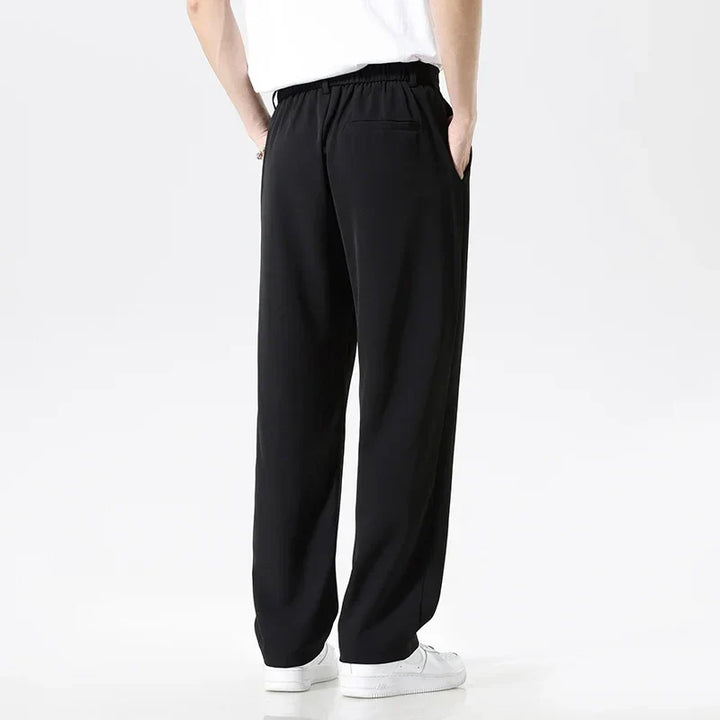 Gray men's relaxed fit dress pants, wrinkle resistant, professional and comfortable for smart casual style.
