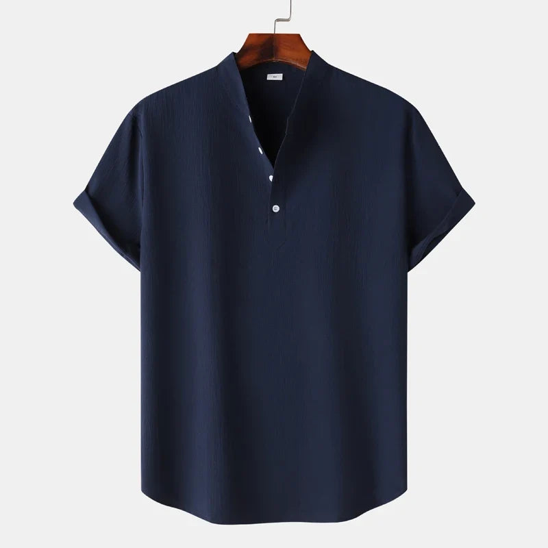 Detail of the soft fabric and button placket on a men's natural tone long sleeve henley shirt.