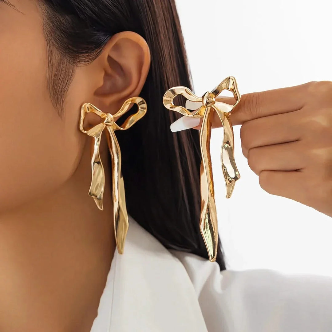 Elegant women's ribbon bow earrings with a polished finish, a delicate fashion accessory & perfect gift for her.