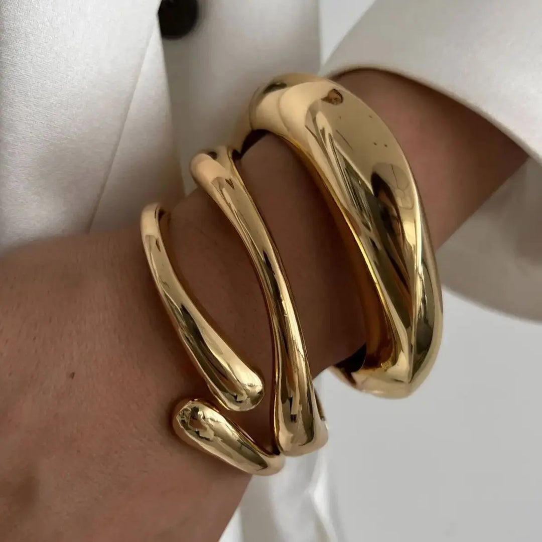 Women's vintage stackable bracelets set, featuring elegant gold and silver sculptural designs for a fashionable accessory.