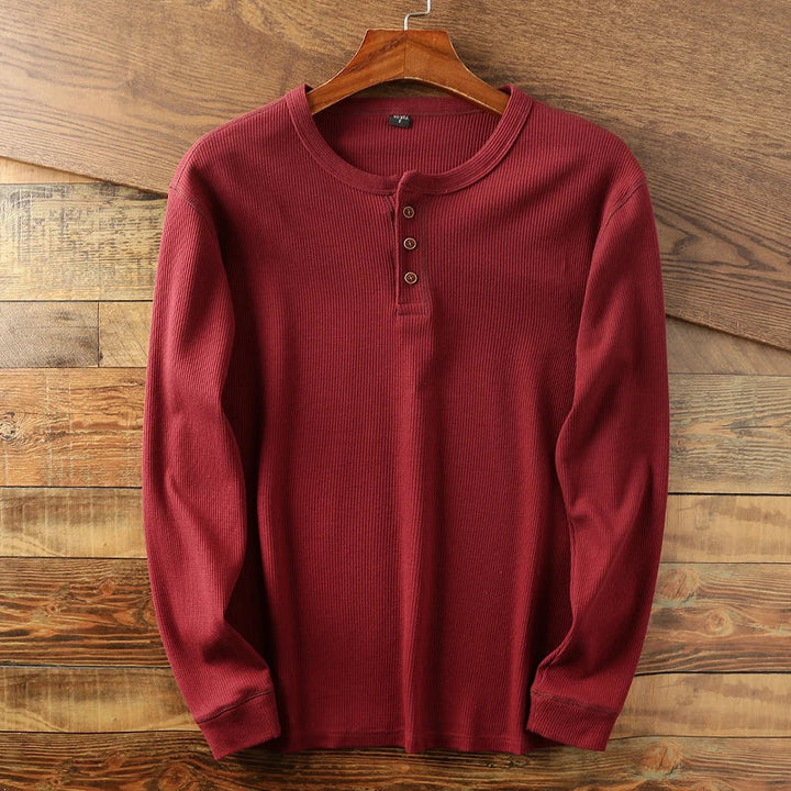 Classic men's black waffle knit long sleeve shirt. Comfortable, versatile top for men.