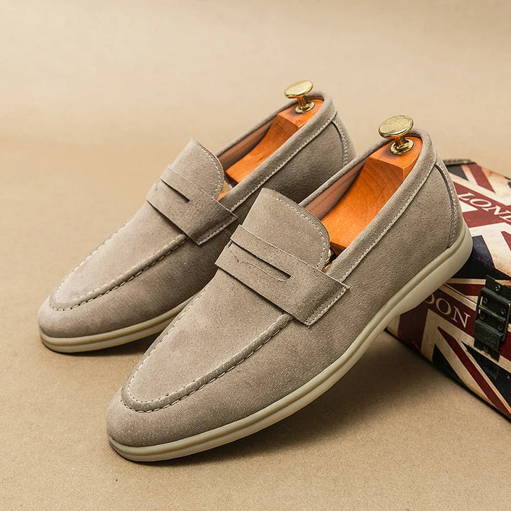 Close-up of black men's Milan slip-on loafers, showcasing fine texture & classic design.