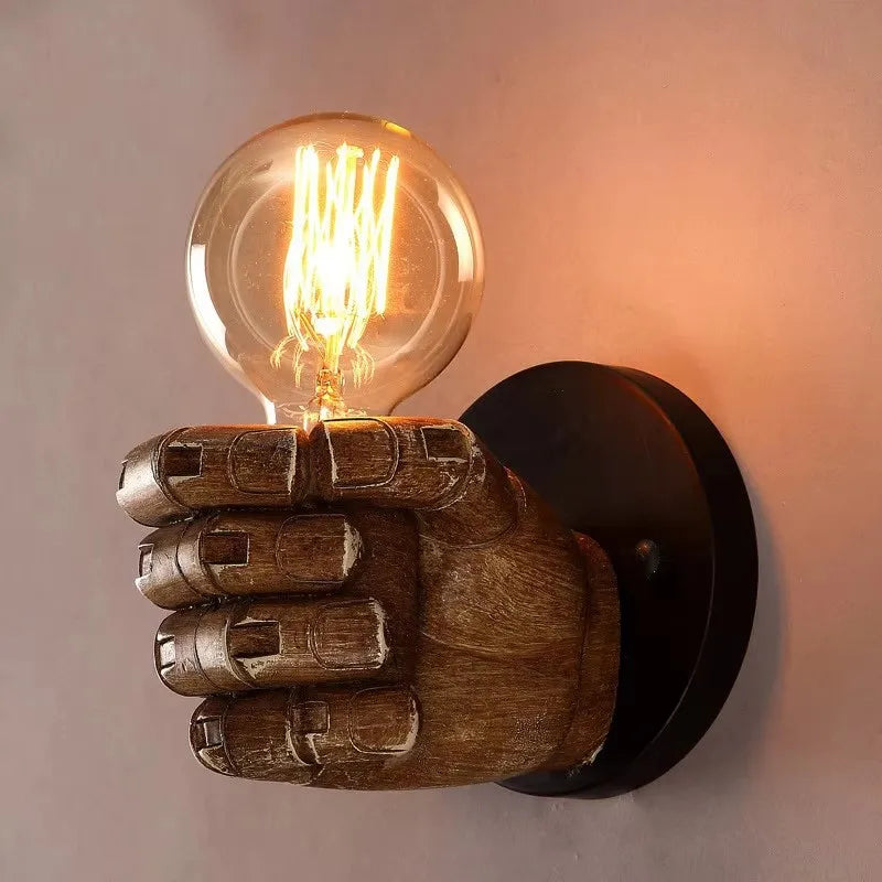 Artistic sculpted resin fist wall sconce. Unique industrial design for modern home & business lighting.