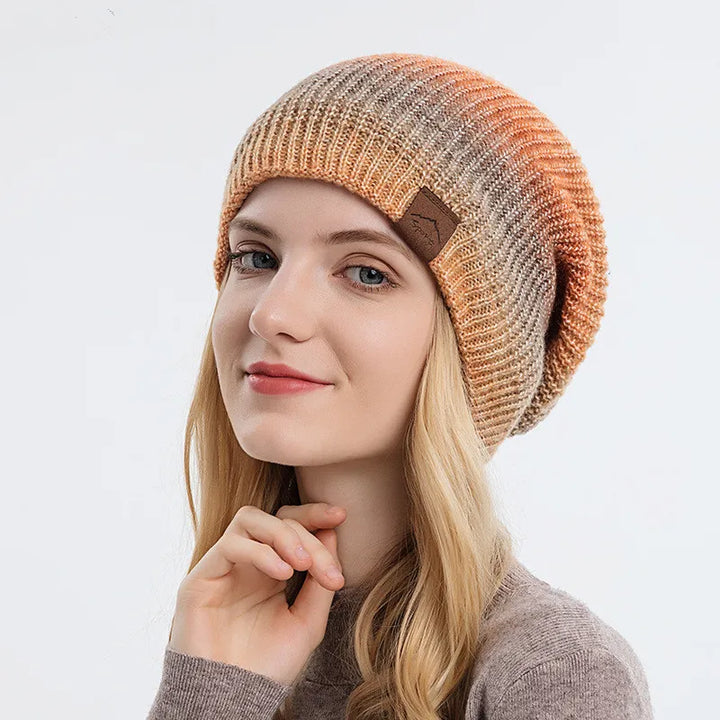 Vibrant rainbow knit beanie, a cozy unisex winter hat for warmth and style.