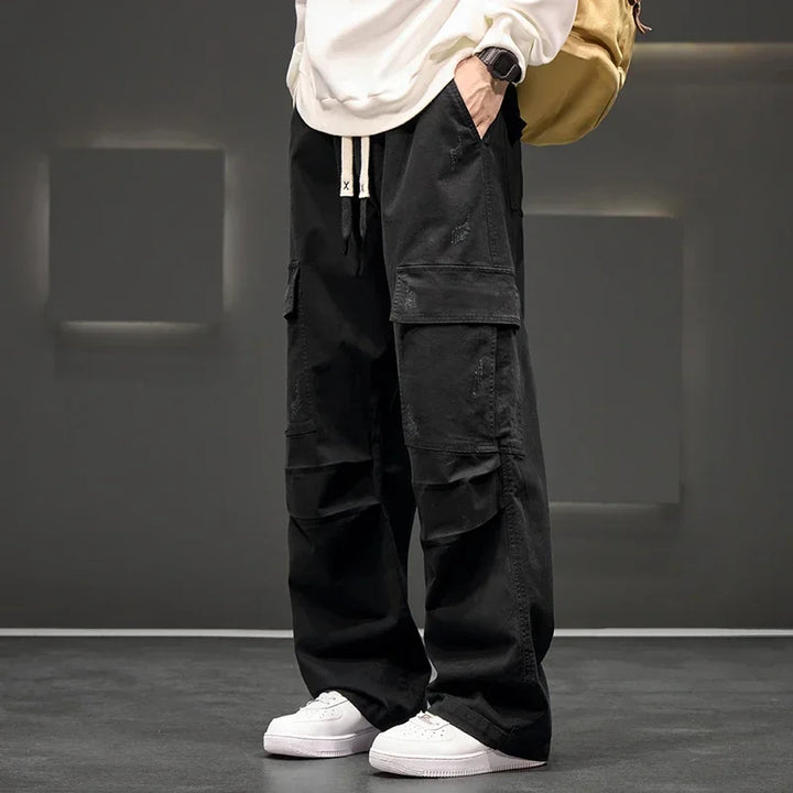 Men's black relaxed fit utility cargo pants with drawstring waist, ideal for casual everyday wear.