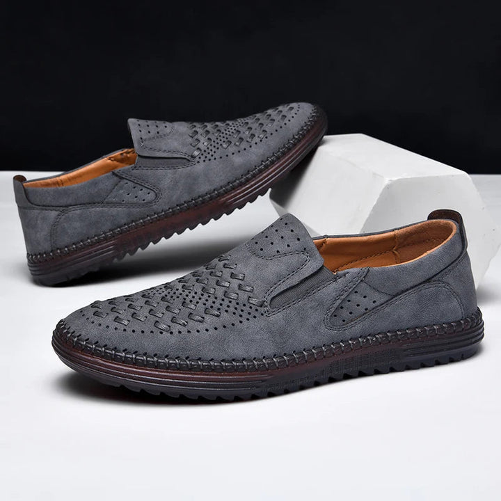 Angled shot of men's comfort footwear, hand-stitched and perforated for breathable all-day wear.