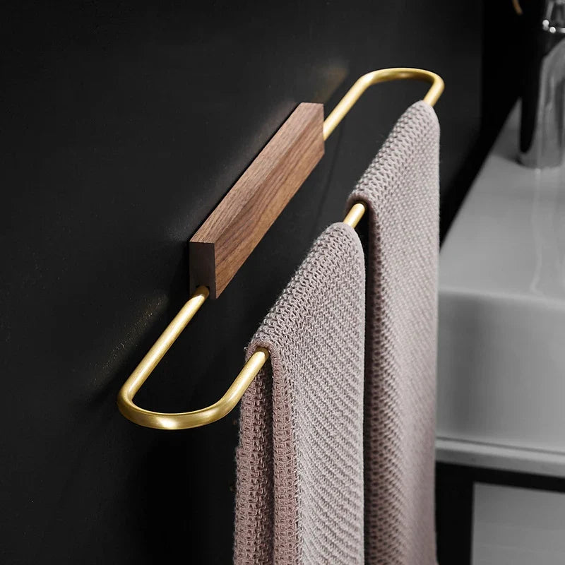 Hearthside walnut towel bar with brass accents for modern minimalist bathroom decor. Wall-mounted wood accent.