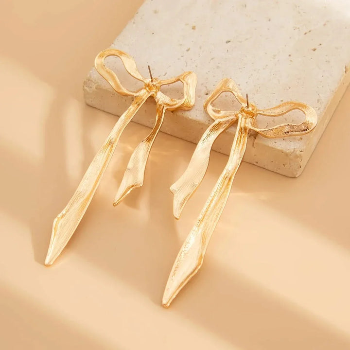 Chic women's ribbon bow earrings, a delicate fashion accessory & elegant gift for her. Versatile jewelry.