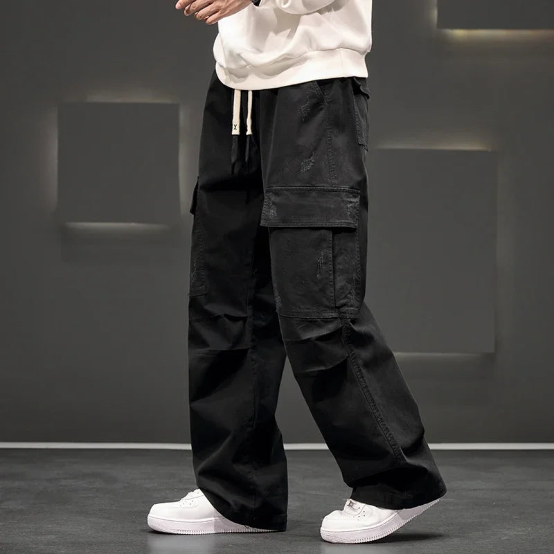 Comfortable men's relaxed fit cargo pants with adjustable drawstring waist, perfect for outdoor utility.