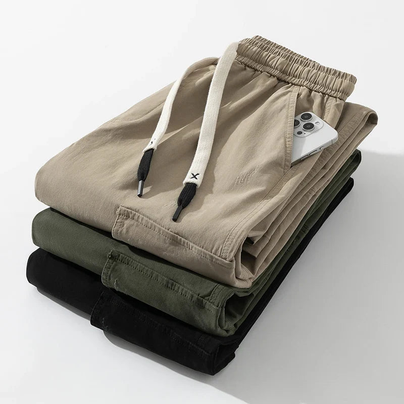 Stylish men's black relaxed fit utility cargo pants featuring a practical drawstring waist and roomy pockets.