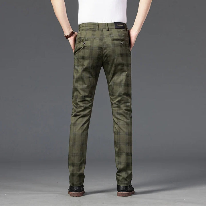 Close-up of men's grey plaid slim fit dress pants, highlighting the pattern and stretch material for comfort.