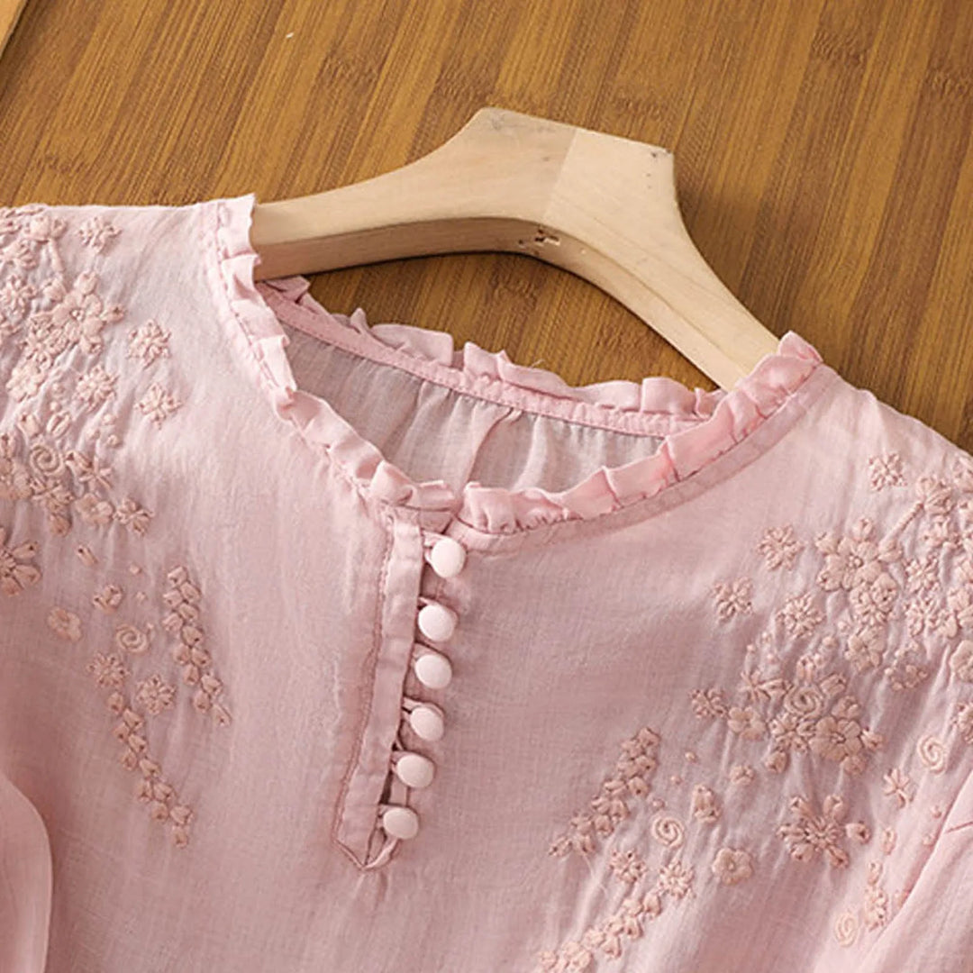Elegant women's embroidered blouse with a button-front design, elbow sleeves, and a stylish loose fit.