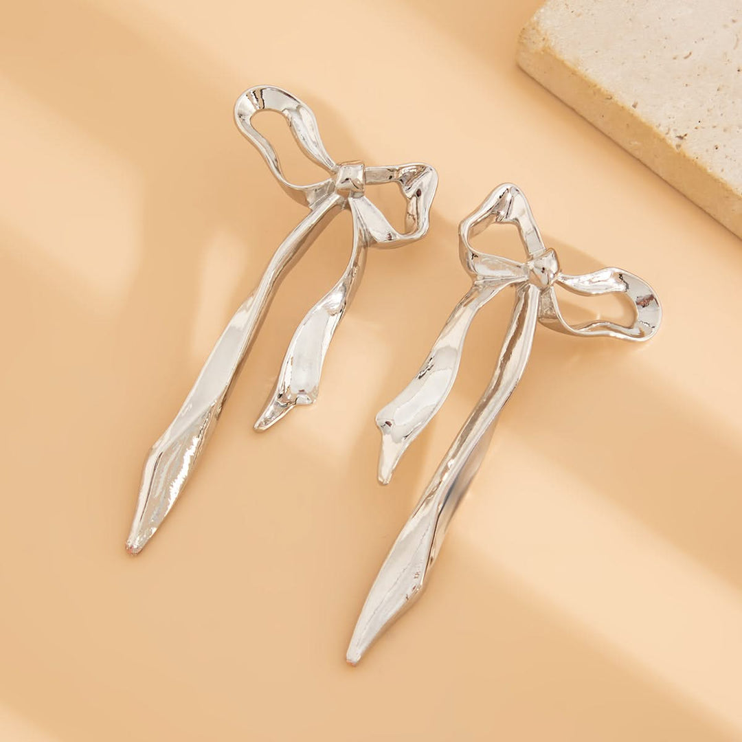 Beautiful ribbon bow earrings for women, featuring a delicate design and polished finish. Elegant fashion jewelry.