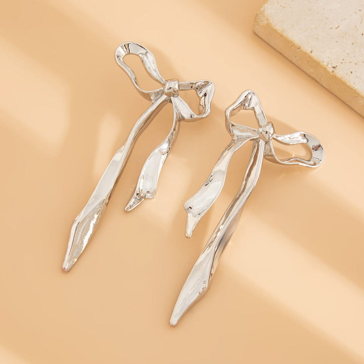 Beautiful ribbon bow earrings for women, featuring a delicate design and polished finish. Elegant fashion jewelry.