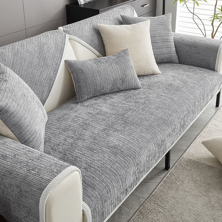 Waterproof sofa cover protecting a beige couch from spills, pet hair, and wear. Durable furniture guard.