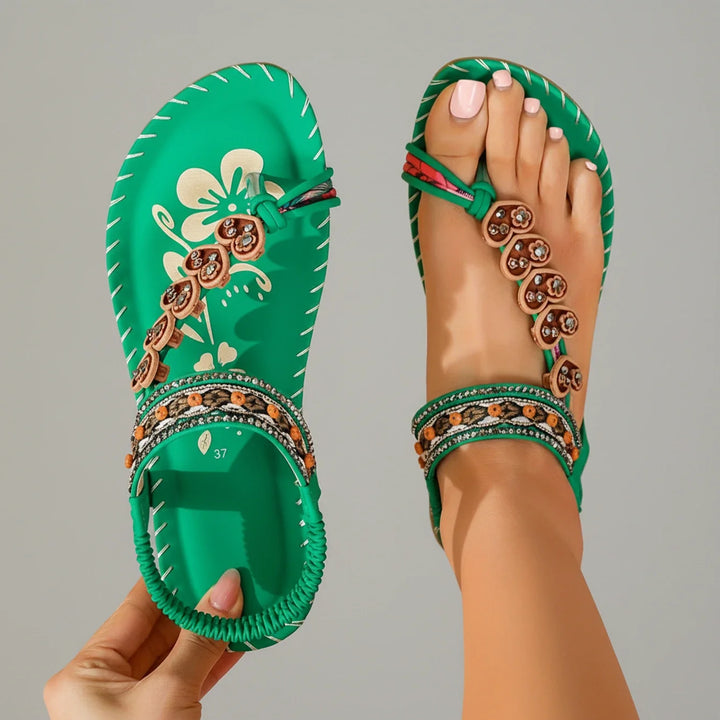 Chic women's flat bohemian thong sandals with a beautiful floral ankle strap for summer.