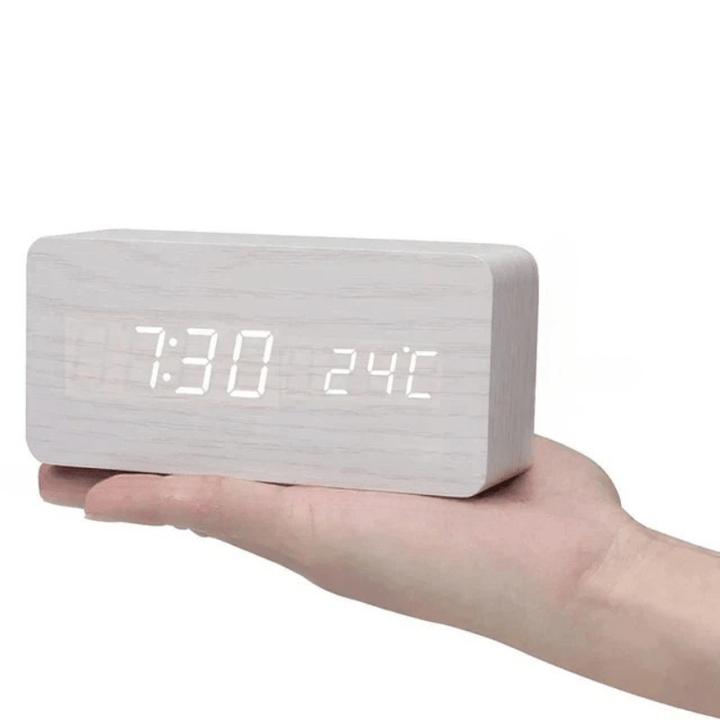 Compact LED wooden desk clock, digital display & voice-activated features.