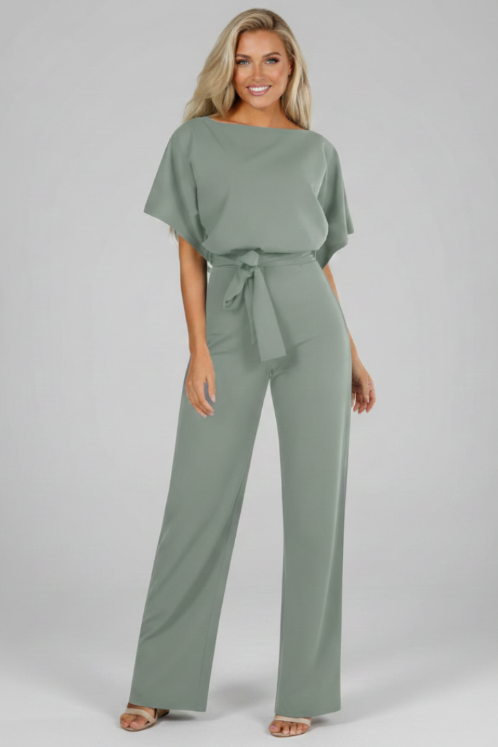 Posed women's short sleeve jumpsuit, straight leg. Casual elegant full-length outfit with a fashionable waist tie for versatility.