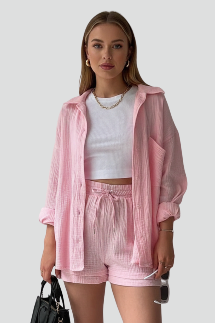 Stylish women's casual two-piece lounge set. Relaxed long sleeve shirt and matching shorts outfit.