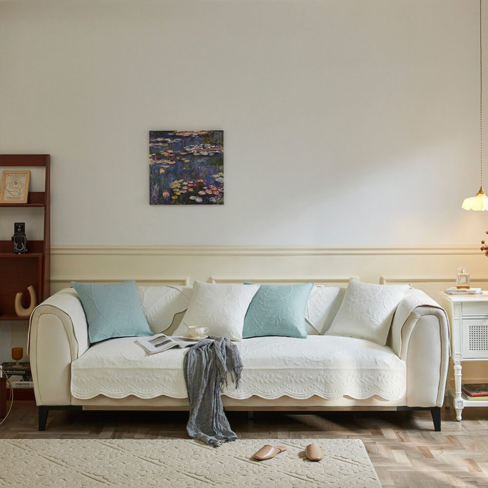 Living room couch featuring a durable, textured cotton boho slipcover in a neutral farmhouse aesthetic.