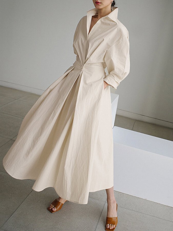 Effortless women's V-neck A-line midi dress with long sleeves & practical pockets. Timeless, versatile style.