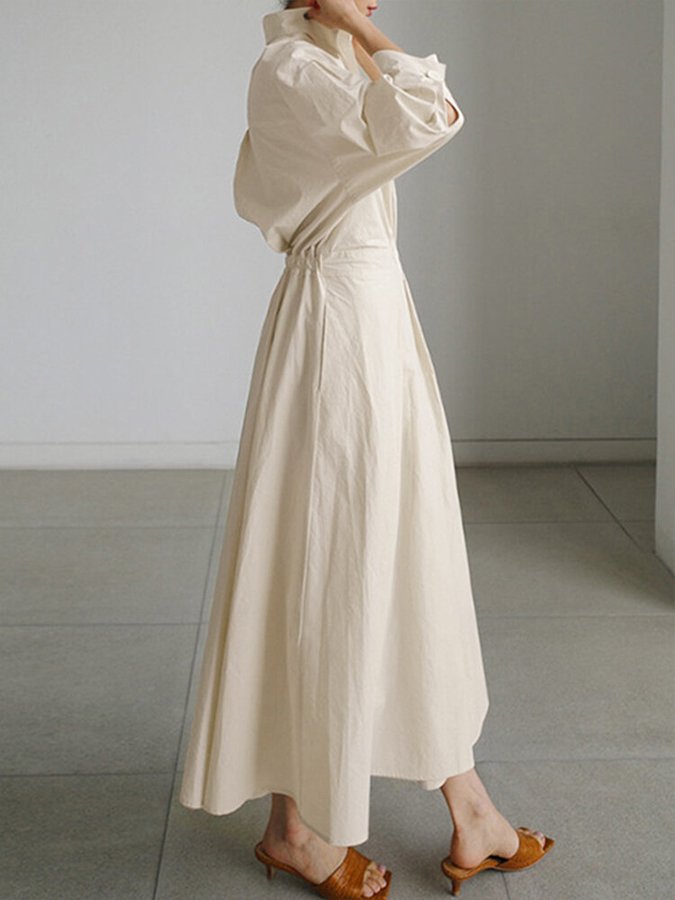Elegant V-neck A-line midi dress for women, featuring long sleeves & pockets. Versatile for any occasion.