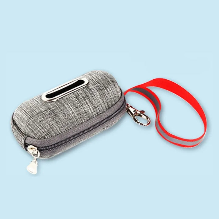 Hand holding a purple pet waste bag dispenser, ready for use during a dog walk, essential pet care item