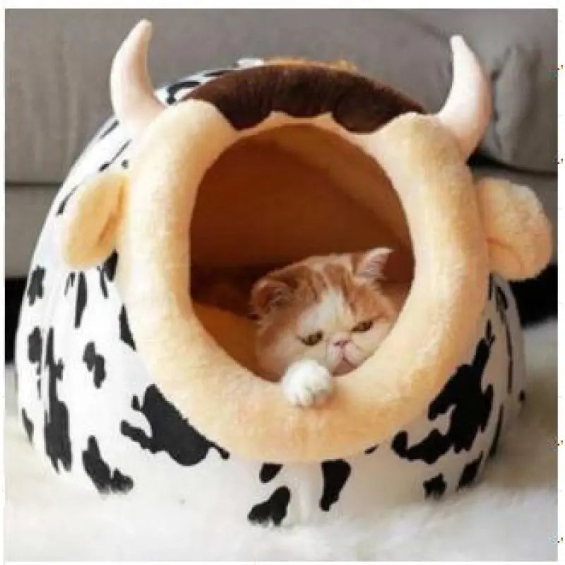 Soft animal print cat bed featuring a cow design, providing a cozy retreat for pets