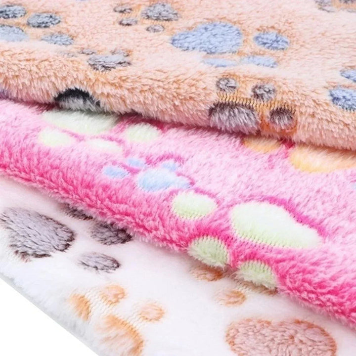 Washable coral fleece pet blanket draped over a dog bed, adding an extra layer of warmth and comfort.