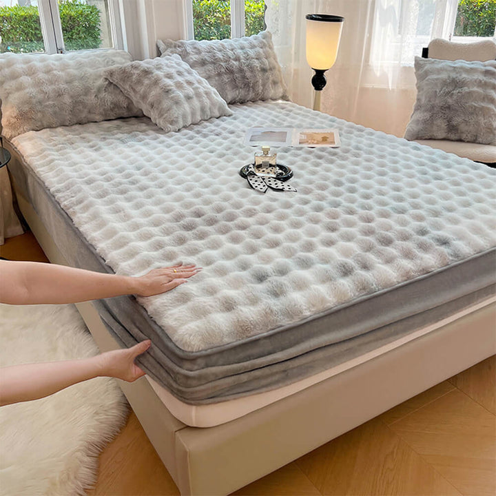 Matching faux rabbit fur fitted sheet and pair of pillowcases, perfect for a cozy bedroom.