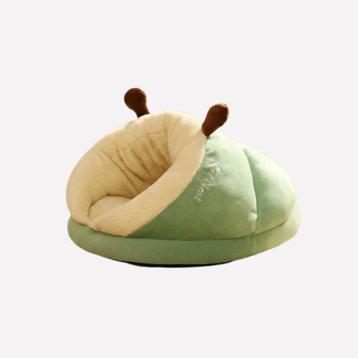 Small dog or puppy nestled comfortably in a soft, cozy slipper-shaped pet bed, perfect for indoor use