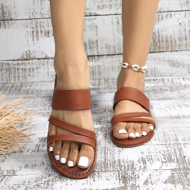 Everyday women's open-toe flat sandals, cushioned cross-strap design for easy slip-on wear.