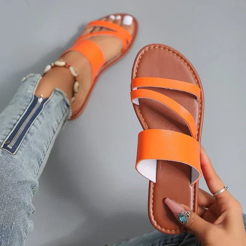 Casual women's summer sandals: cushioned flat base with elegant cross-straps, easy slip-on.