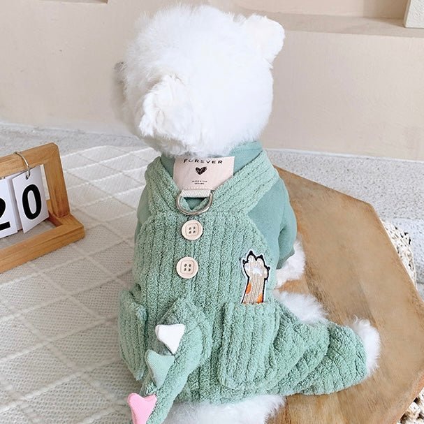 Cute small dog in green plush dinosaur pet jumpsuit, warm winter dog outfit with hood and tail