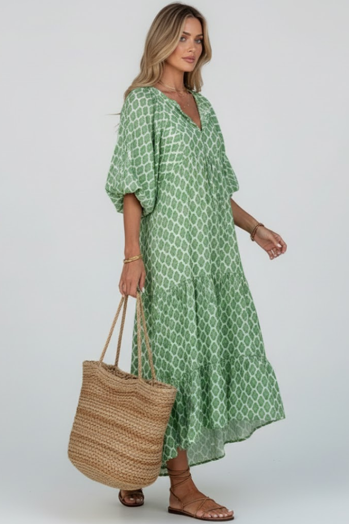 Comfortable dark green V-neck summer dress with short sleeves and a flowy layered skirt. Casual and stylish.