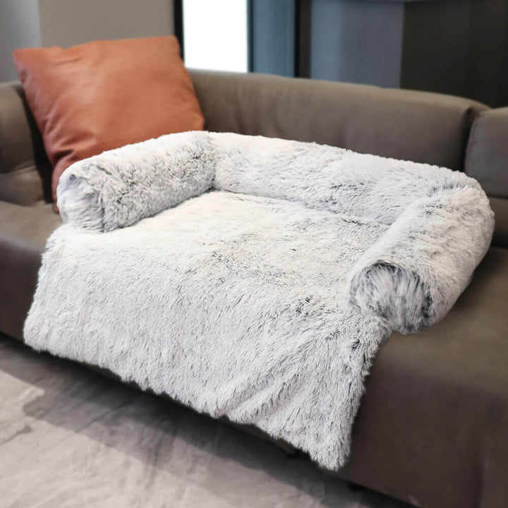Washable pet couch cover, designed as a calming dog bed, fitting neatly onto a sectional sofa