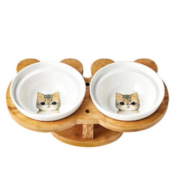 Cat feeding station featuring dual ceramic bowls and a raised bamboo stand for improved posture.